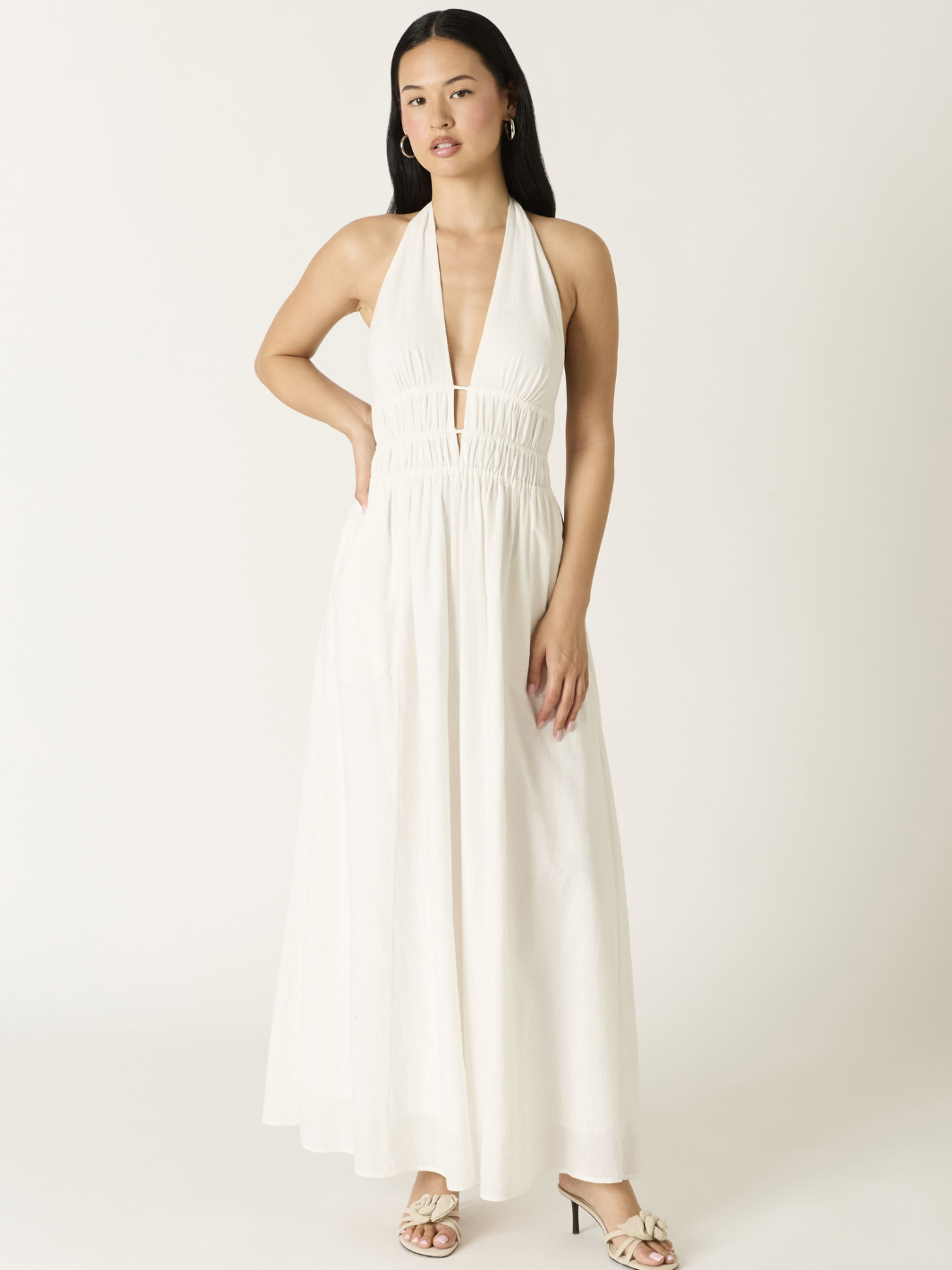 Soleil Plunge Halter Maxi Dress on model with deep plunge neckline, ruched waist, flowing A-line skirt.
