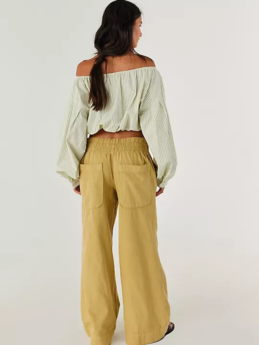 Model in off-shoulder striped top with tan Free People Breezy Denim Pull-On Jeans, wide-leg, mid-rise.
