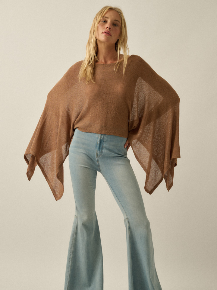 Daydrift Sheer Knit Poncho Sweater worn oversized and airy in caramel brown over light-wash jeans.