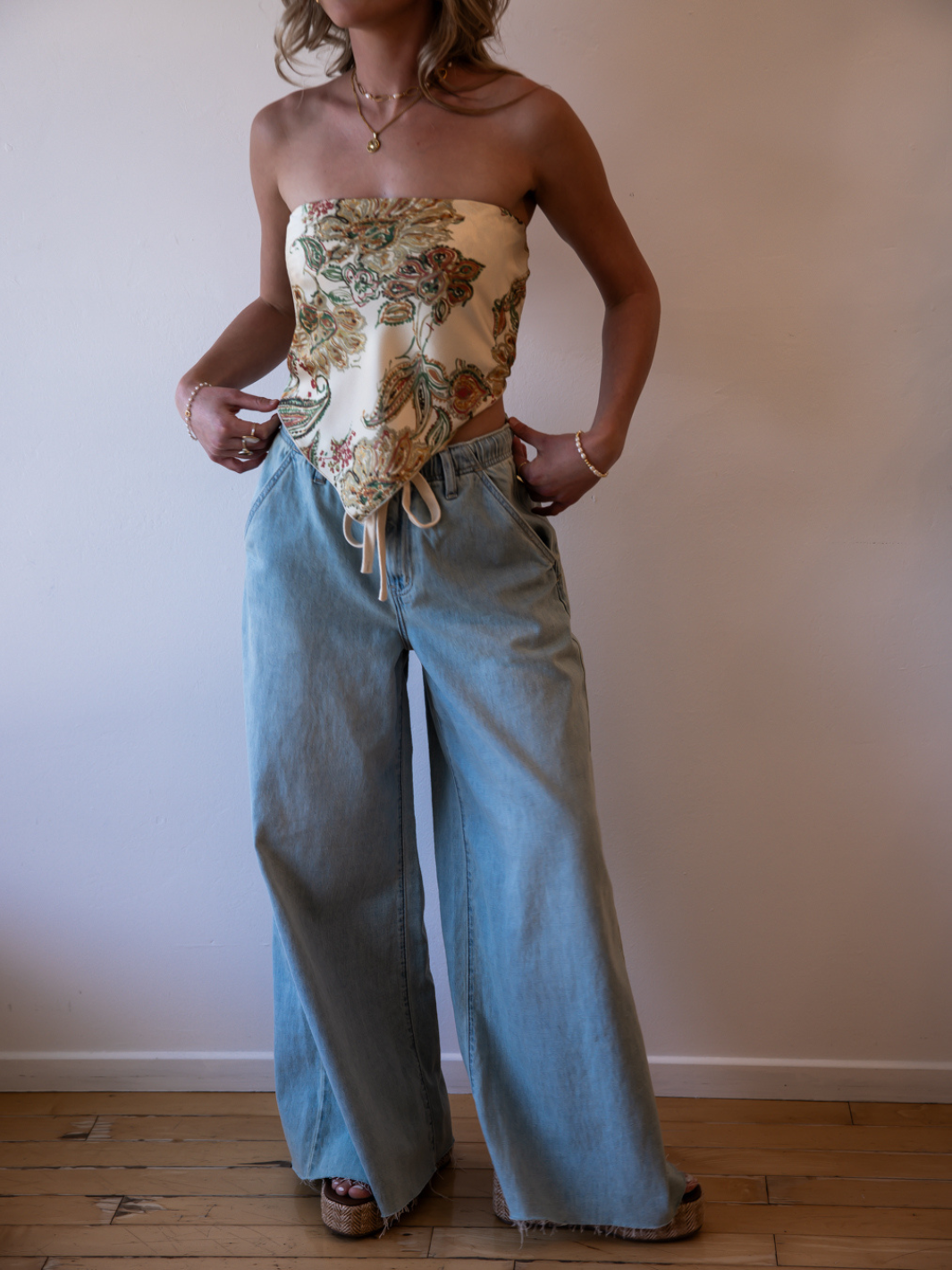 Daze Denim Cabana wide-leg pull-on jeans in a light wash worn with a floral strapless top.