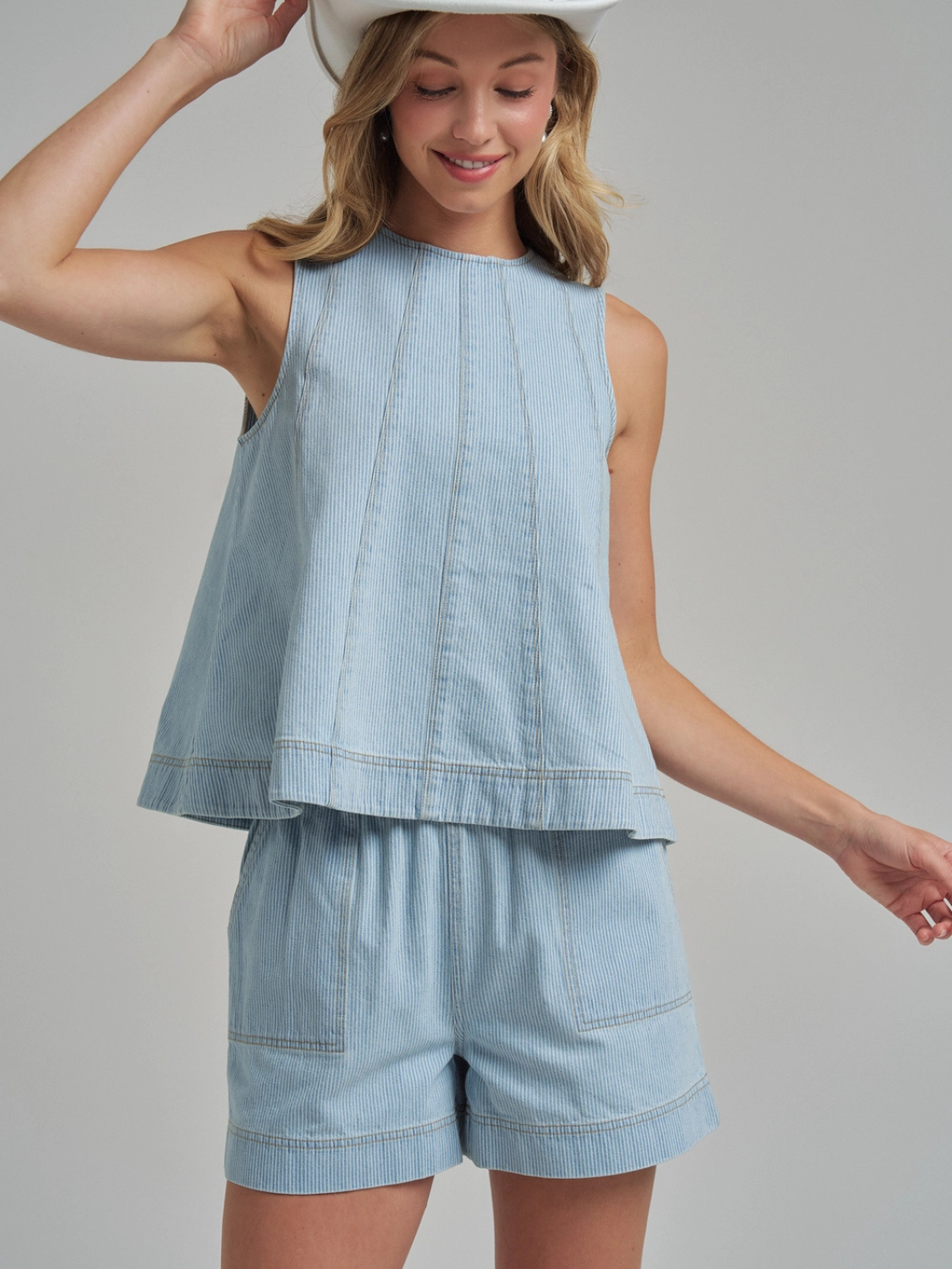 The Sutton Pinstripe Denim Tank Top with panel-seam detailing in light blue, shown with matching Sutton shorts.