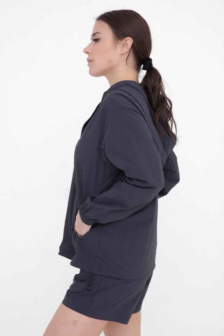 Rain or shine, our water resistant woven active hoodie is a must have. It features zippered hand pockets, a comfortable boyfriend fit, a snap placket at neckline, elastic at the sleeve cuffs, and an adjustable bungee at the hem.