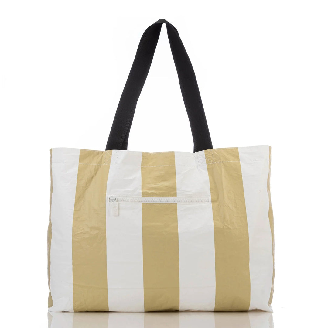 Aloha Collective Monstera Seaweed tote: white and gold vertical stripes, black handles, front zip.