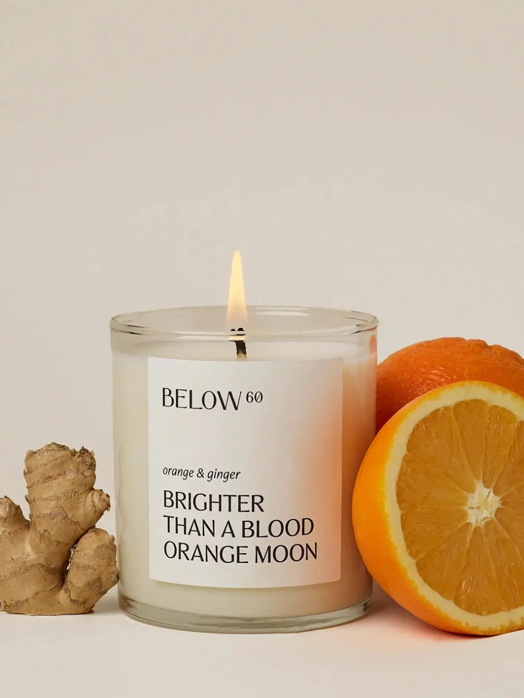 BELOW 60- Brighter Than A Blood Orange Moon candle by BELOW 60; orange & ginger scent with a sliced orange.