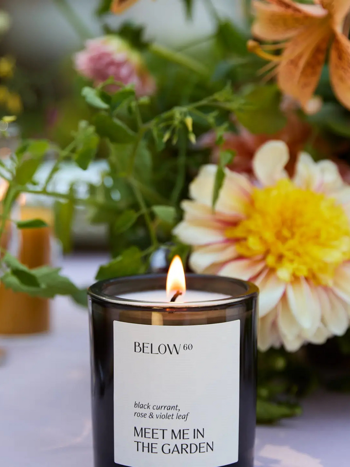 BELOW 60 - Meet Me in the Garden candle by Below 60, velvet blooms and greenery surround the jar.