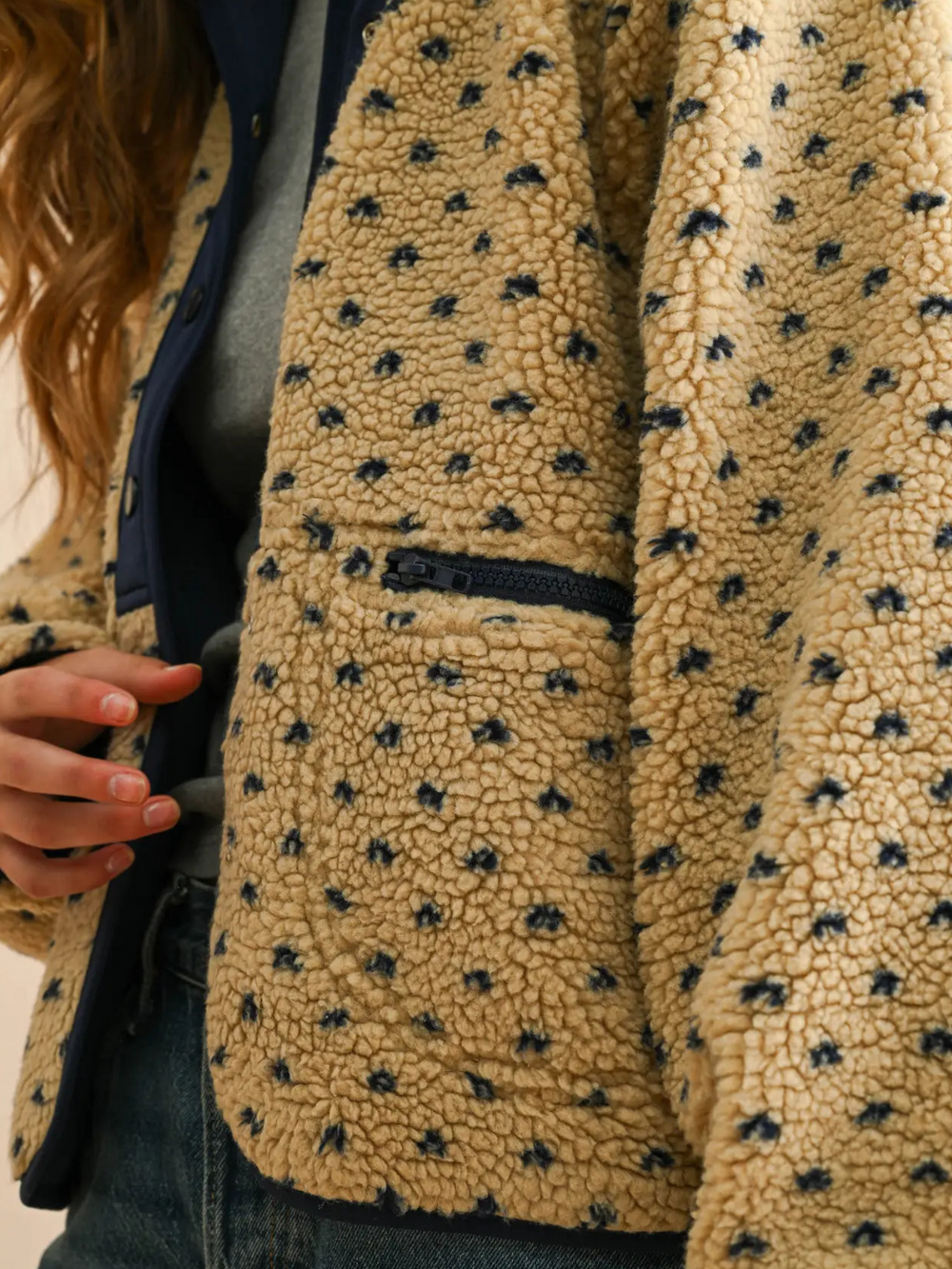 Beige Canyon Bloom patterned sherpa fleece jacket with blue floral dots and zip pocket.