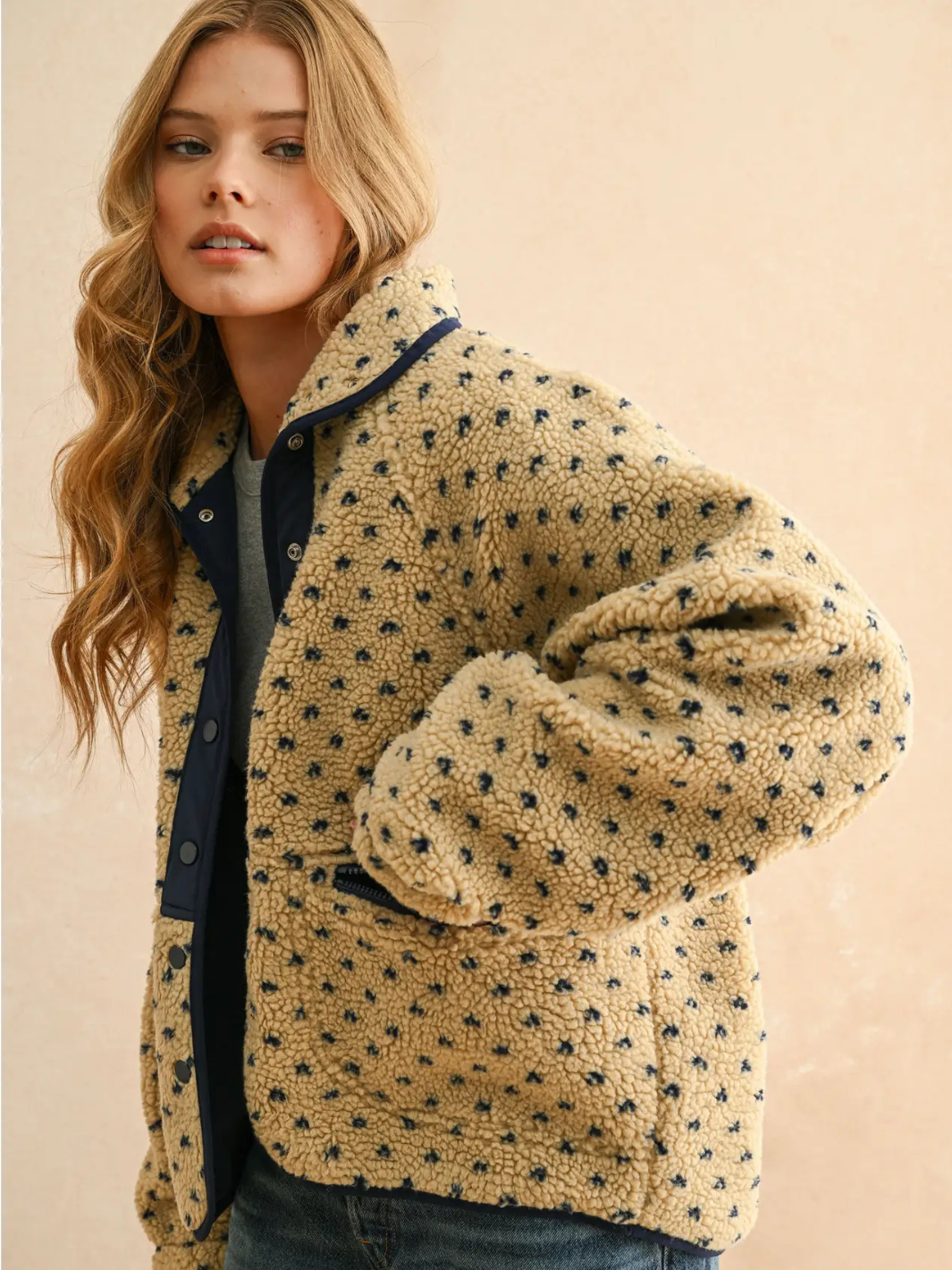 Canyon Bloom patterned beige sherpa fleece jacket with navy dots, contrast trim, button-up front.