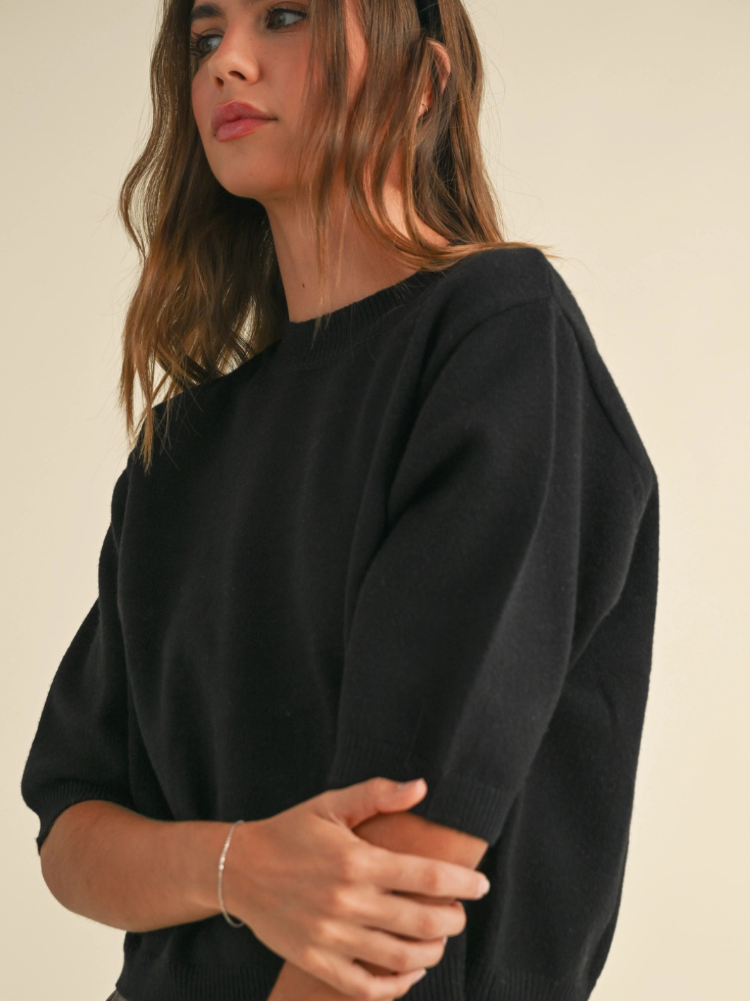 Cleo ribbed knit short sleeve sweater top in black worn by a model, crew neckline and softly structured silhouette.
