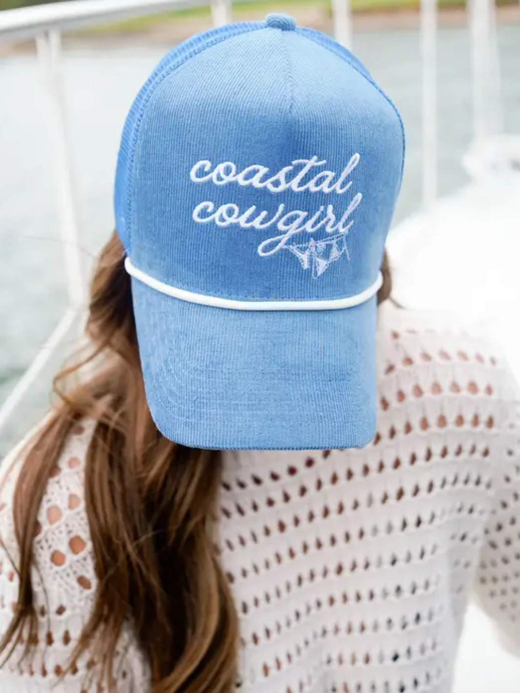 Coastal Cowgirl blue corduroy trucker hat with white rope trim and embroidered script.