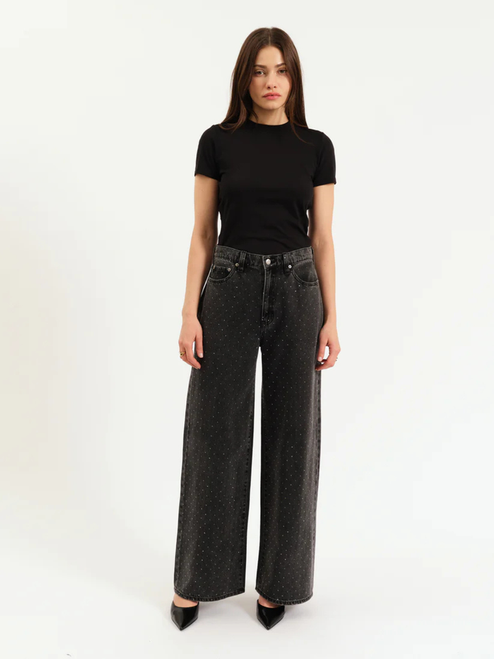 DAZE DENIM Far Out High Rise Wide Leg Jeans in dark wash with speckled white dots, modeled with black tee.