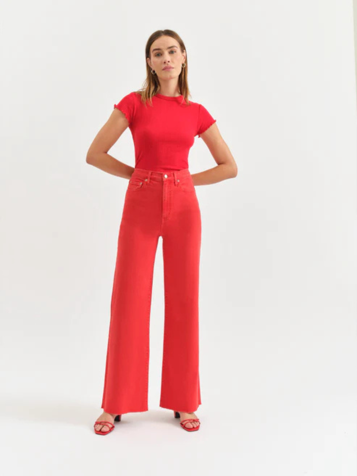 Model in DAZE DENIM Far Out High Rise Wide Leg Jeans in bright red.