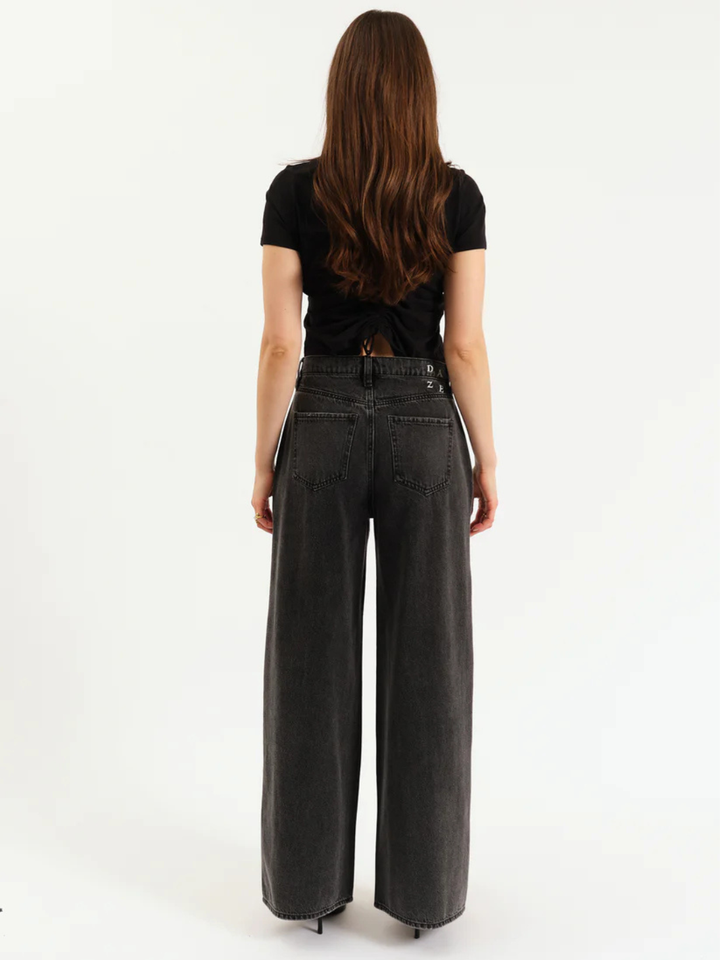 DAZE DENIM Far Out High Rise Wide Leg Jeans on model, dark wash wide-leg silhouette with back pockets.