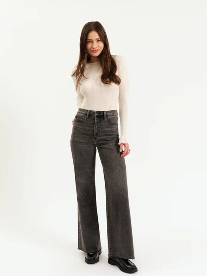 DAZE DENIM - Farout High Rise Wide Leg Jeans worn by a model in dark gray wash with cream sweater.