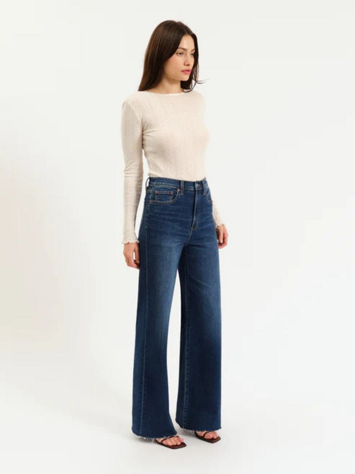 DAZE DENIM - Farout High Rise Wide Leg Jeans in light wash worn by a model; modern cool girl style.