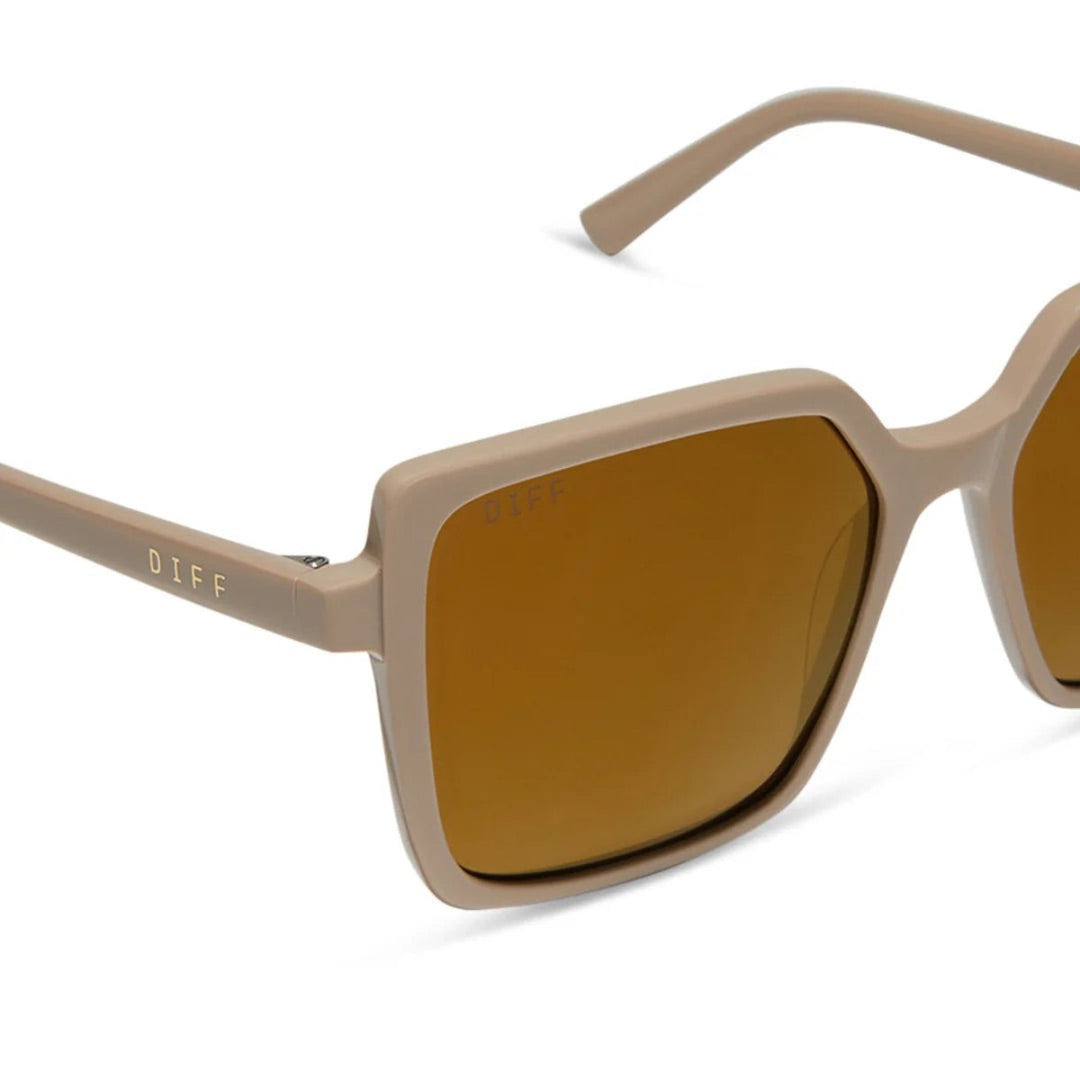 Beige-framed sunglasses with brown tinted lenses on a white background.