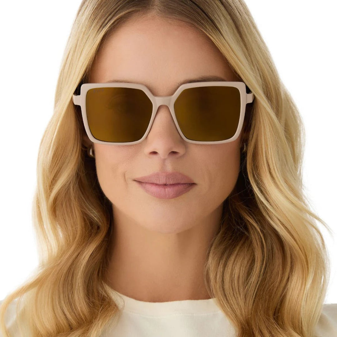 Beige-framed sunglasses with brown tinted lenses on a white background.