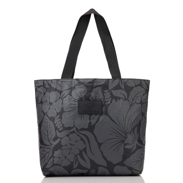 Black Heipua Day Tripper tote with a tonal charcoal hibiscus and leaf print and black straps, front view