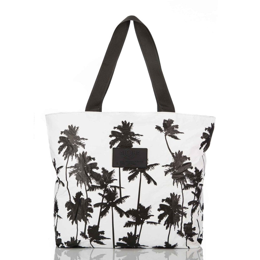 White Coco Palms Day Tripper tote with black palm tree silhouettes and black straps, front view