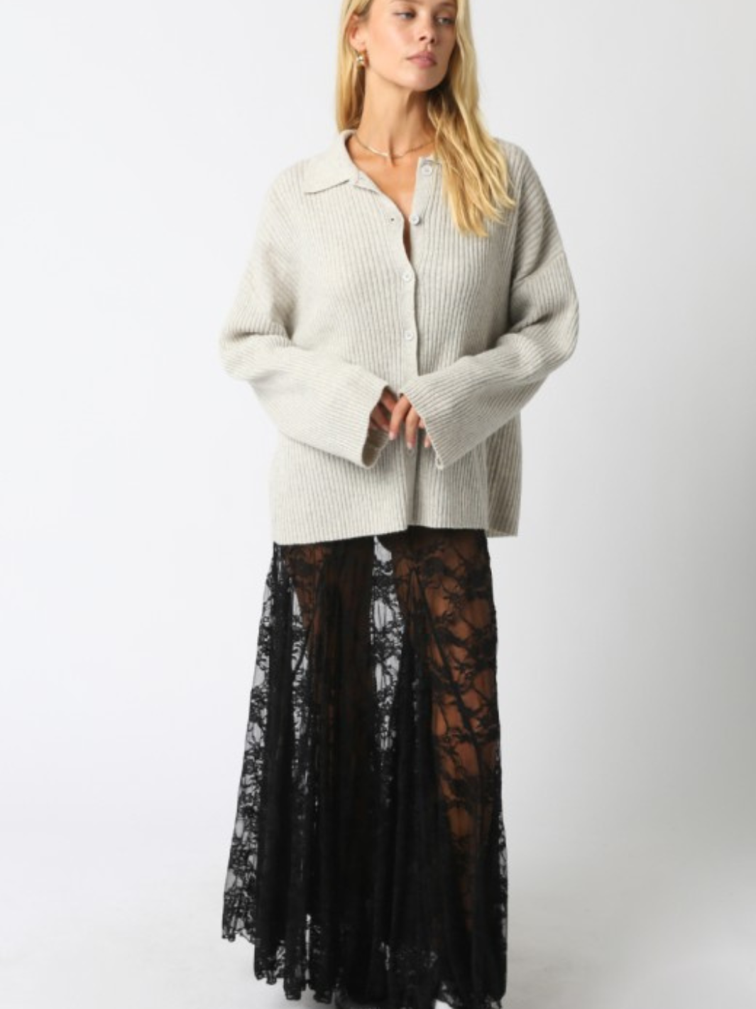 Diana Lace Skirt: sheer black lace maxi with relaxed drape, paired with a chunky cream knit sweater.
