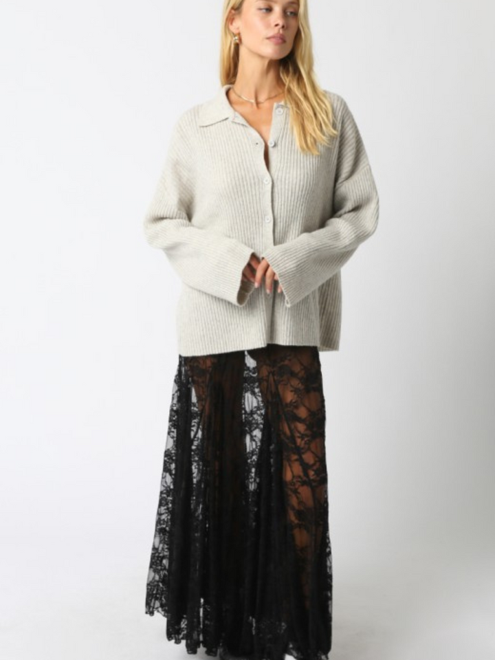 Diana Lace Skirt: sheer black lace maxi with relaxed drape, paired with a chunky cream knit sweater.