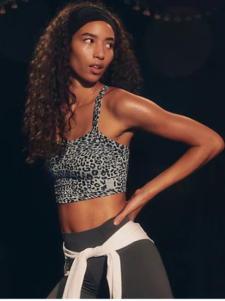 Flirty and fitted, the FREE PEOPLE - All Clear Cami Leopard Top features a chic criss-cross back for effortless style.