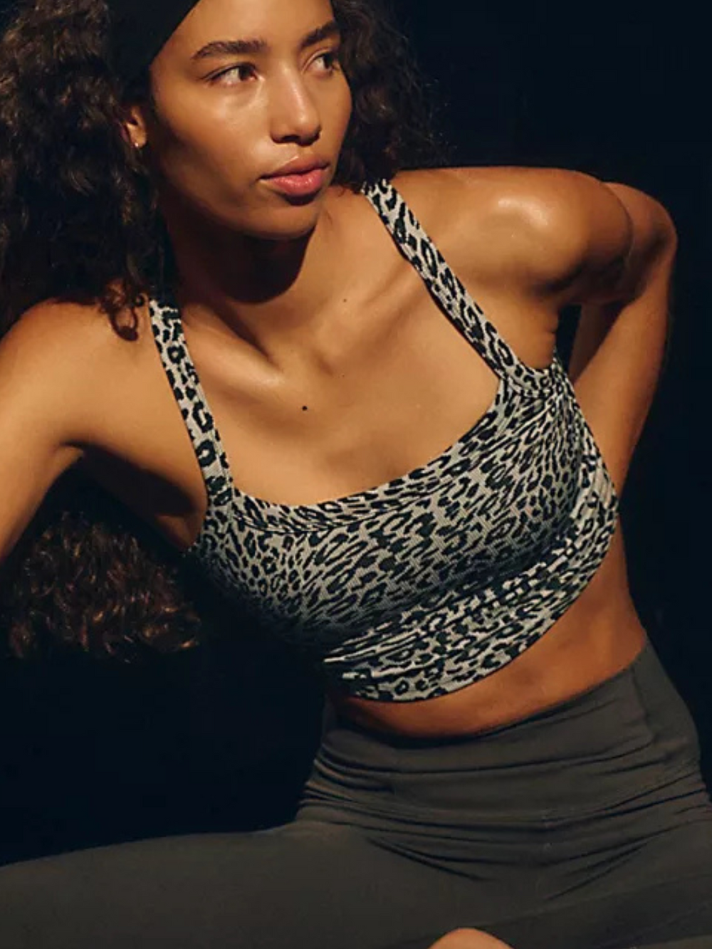 Stylish model wearing the FREE PEOPLE - All Clear Cami Leopard Top, featuring a flattering square neckline and criss-cross back.