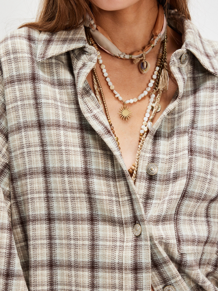 Effortlessly stylish, the FREE PEOPLE - Ashley Plaid Shirt Top features a timeless oversized plaid design.