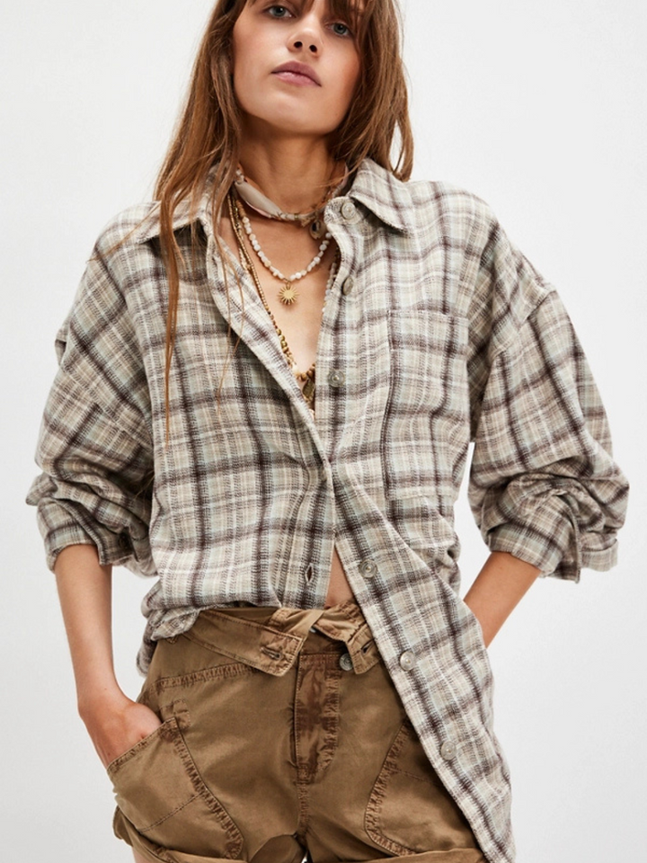 Stylish model wearing the FREE PEOPLE - Ashley Plaid Shirt Top, showcasing its oversized, comfy design. Perfect for layering.