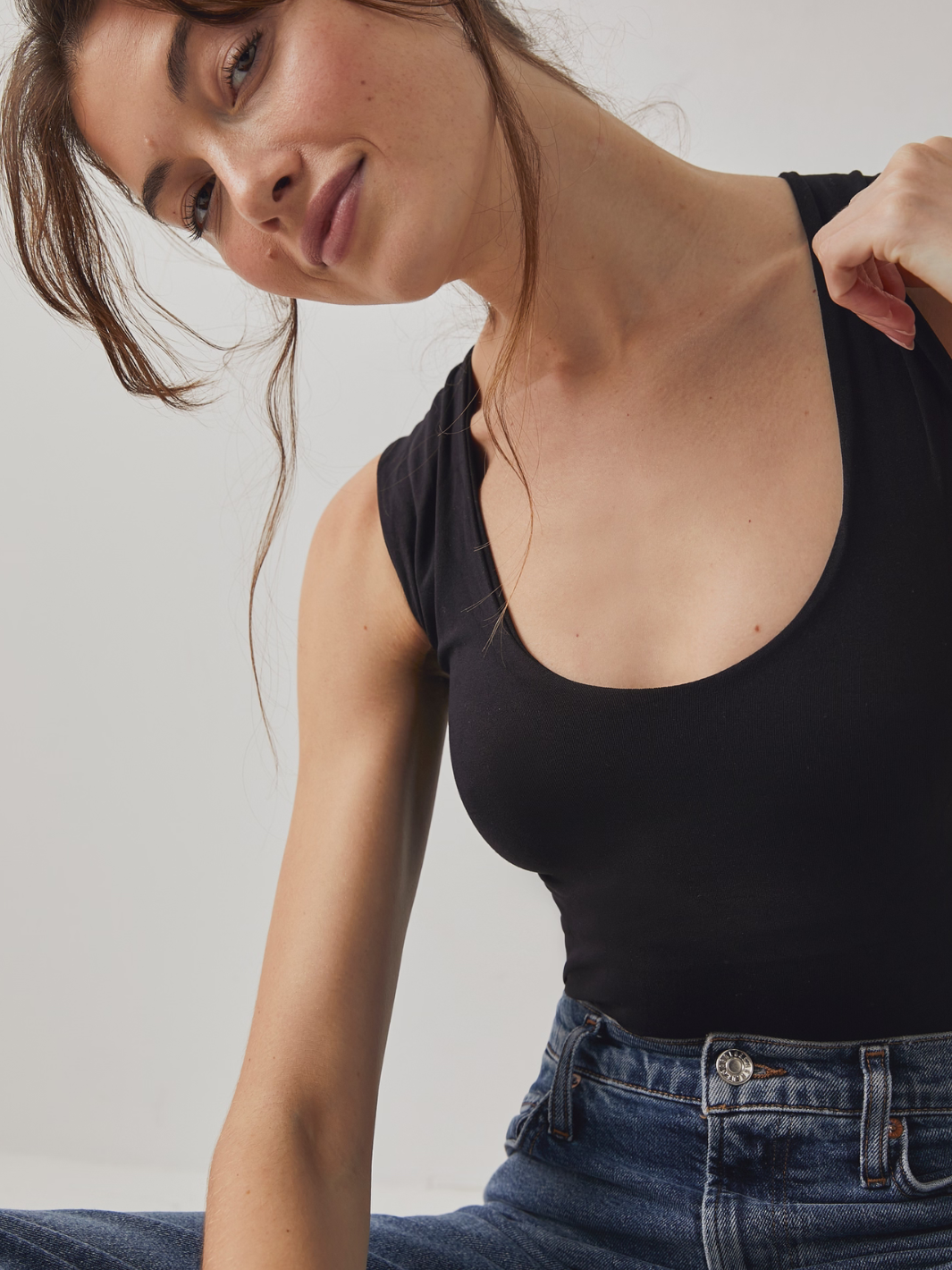 Sleek and stylish, the FREE PEOPLE - Clean Lines Muscle Cami Top offers a second-skin fit for effortless layering.