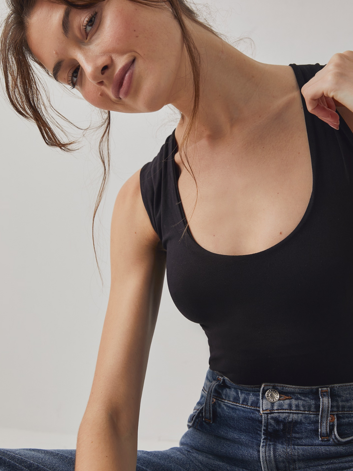 Sleek and stylish, the FREE PEOPLE - Clean Lines Muscle Cami Top offers a second-skin fit for effortless layering.