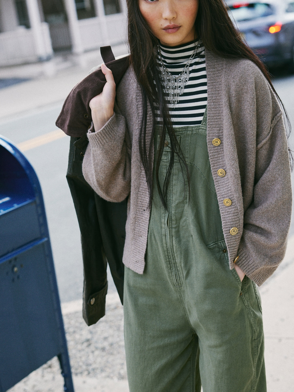 Stylish model wearing the FREE PEOPLE - Cool of the Night Cardi, a cozy oversized cotton knit cardigan.