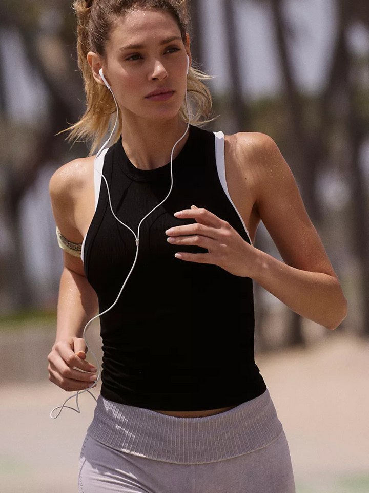 Run in style with the FREE PEOPLE - Dynamite Tank Top, featuring a fitted silhouette and racerback design.