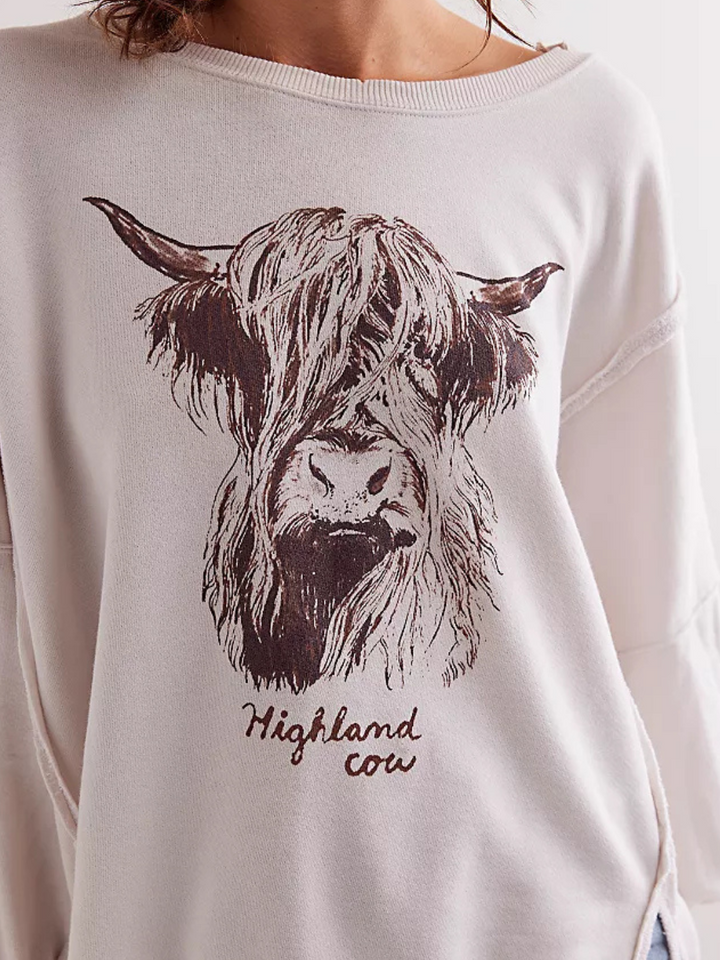 FREE PEOPLE - Graphic Camden Highland Cow showcases a vintage-inspired long sleeve with a relaxed fit and cow graphic.
