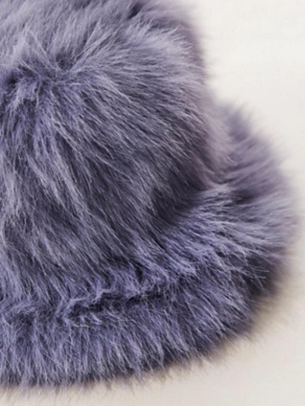 Free People Ice Queen bucket hat in lavender faux fur, close-up of plush texture.