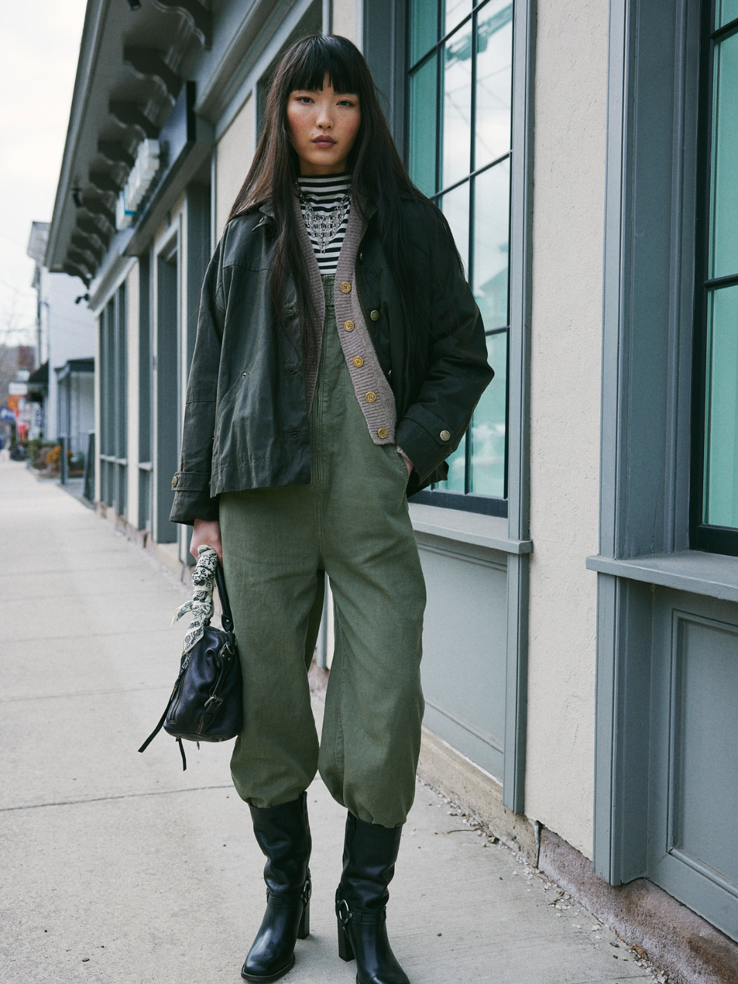 Stylish model wearing the FREE PEOPLE - Jude One Piece Jumpsuit, showcasing its relaxed and utility-inspired design.