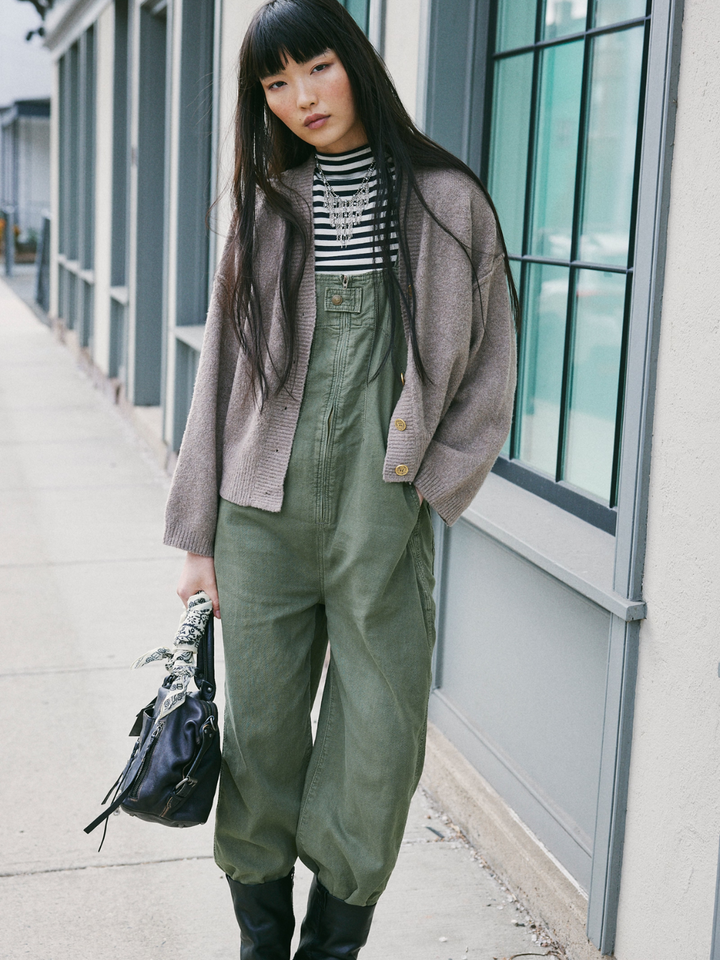 Model showcases the relaxed FREE PEOPLE - Jude One Piece Jumpsuit, perfect for effortless, cool layering.