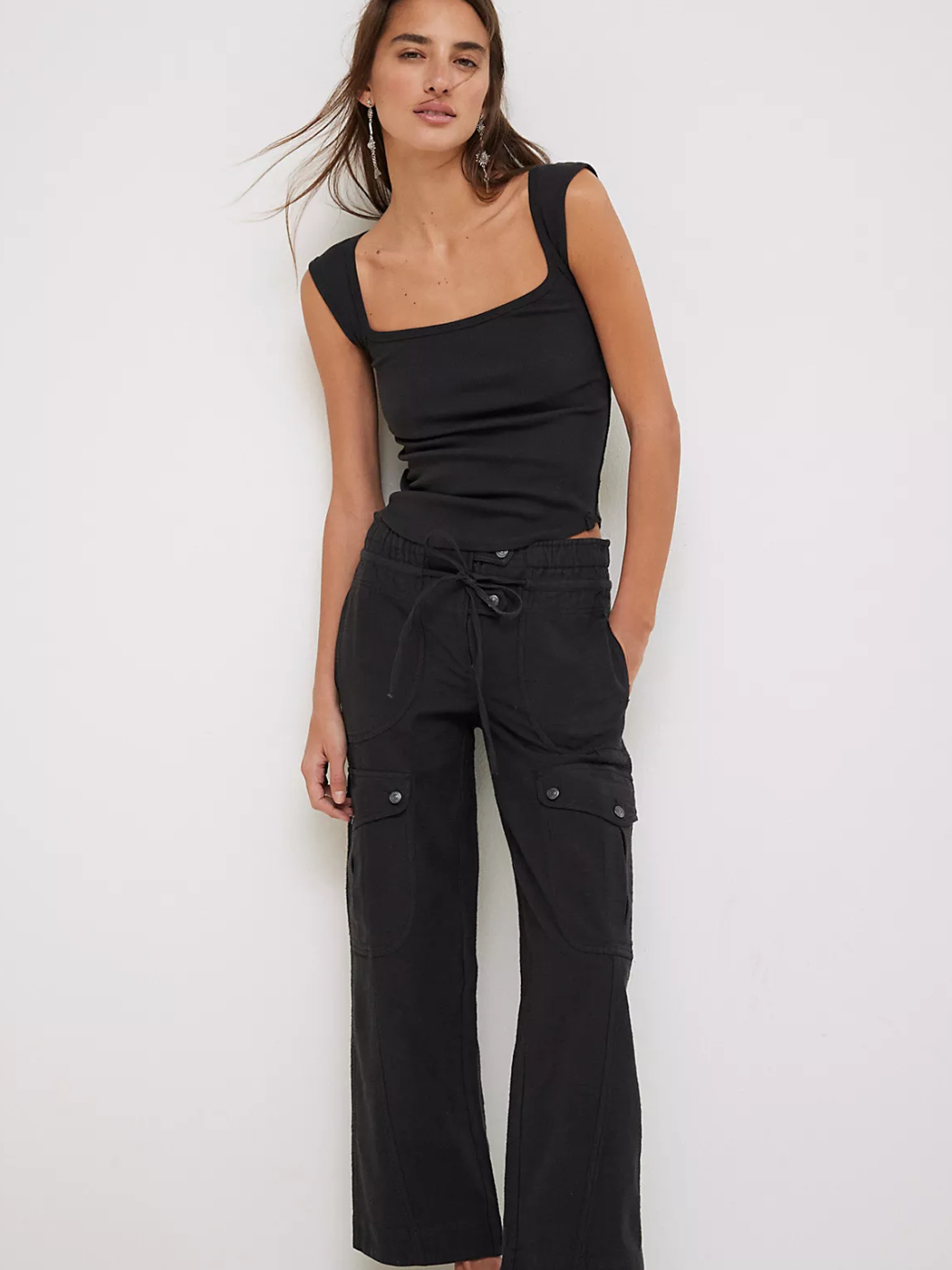 Stylish model showcasing FREE PEOPLE - Park Ave Pant, featuring a slim fit and cargo-inspired design for modern flair.