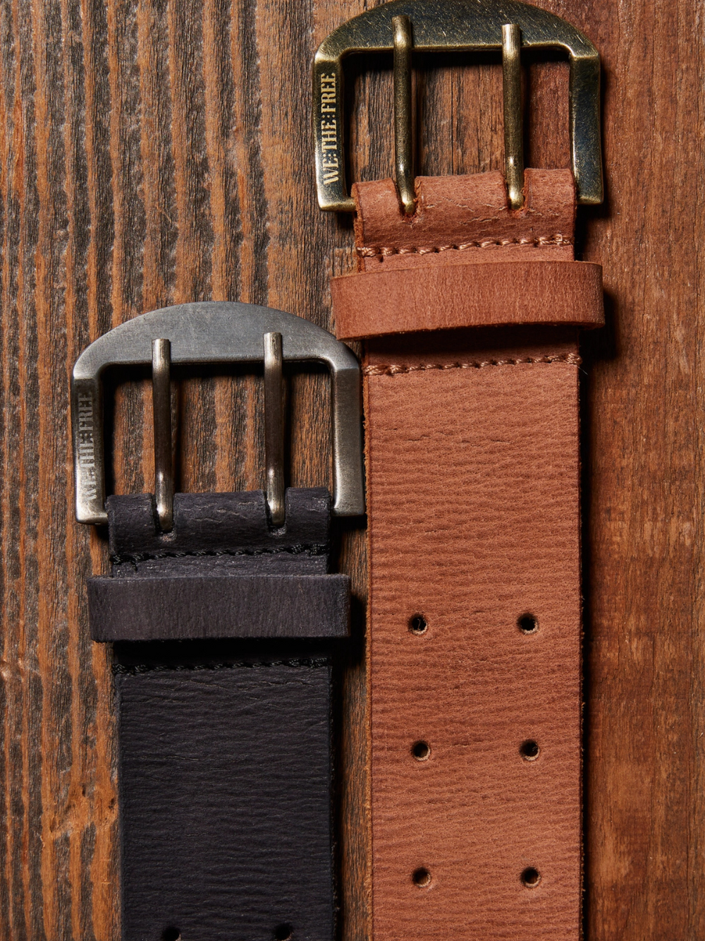 FREE PEOPLE - WTF Double Cross Belt showcases dual leather straps with unique buckles, perfect for adding style to any outfit.