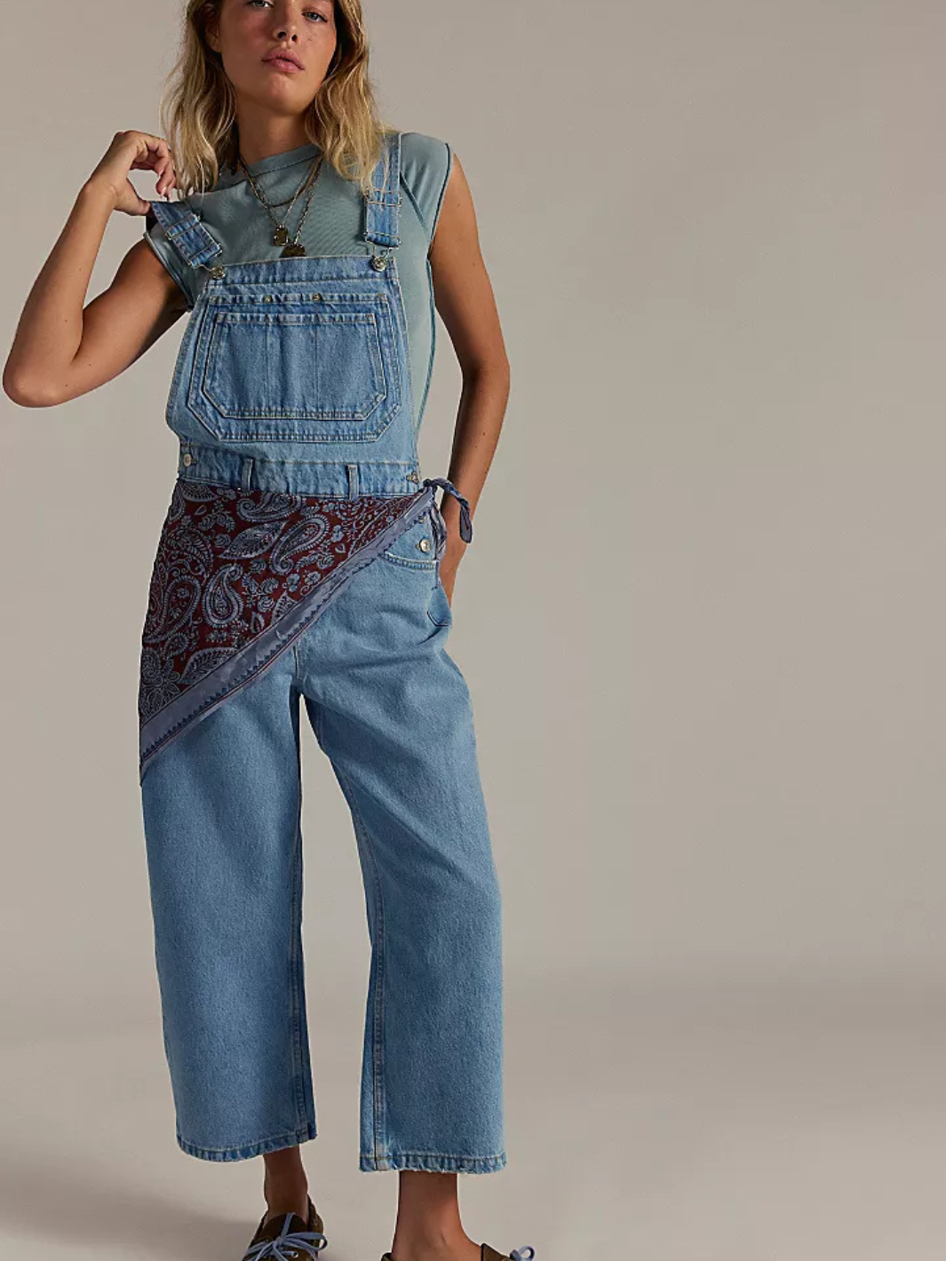 Stylish woman modeling FREE PEOPLE - We The Free Deep Trance Overalls with a relaxed fit and utility design.