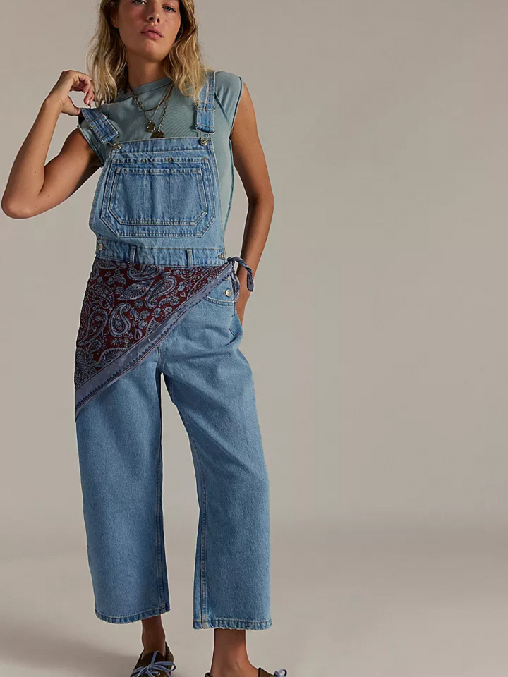 Stylish woman modeling FREE PEOPLE - We The Free Deep Trance Overalls with a relaxed fit and utility design.