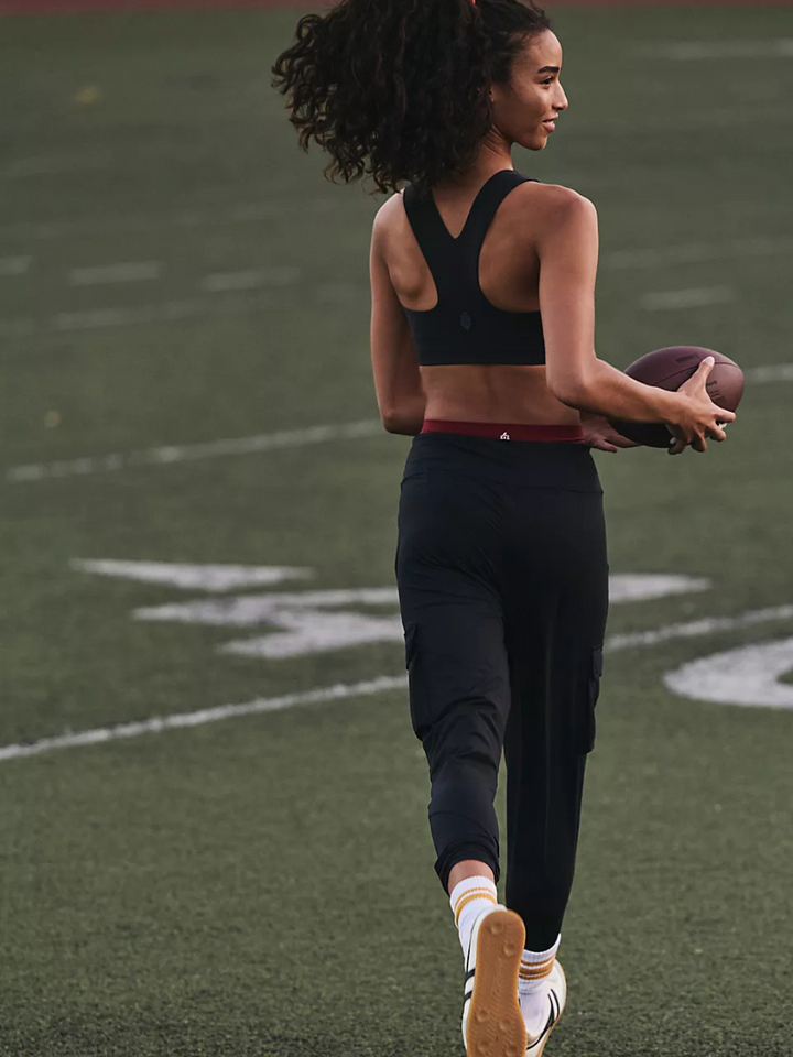 Stylish athlete wearing the FREE PEOPLE - Win Win Sports Bra, perfect for intense workouts and dynamic movement.