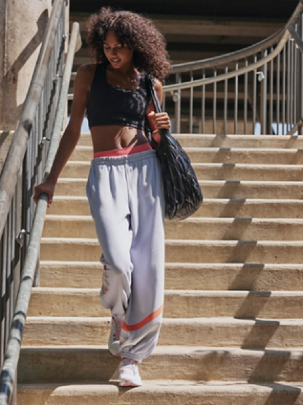 Stylish model wearing the FREE PEOPLE - Win Win Sports Bra, perfect for high-intensity workouts and athleisure looks.