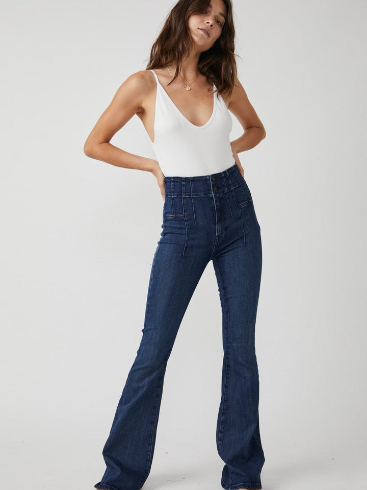 Trendy high rise jeans by Free People, made from flexible denim fabric, perfect for a fashionable and comfortable fit.