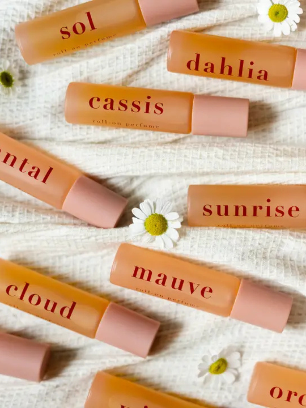 Ginger June Roll-On Body Perfume displayed among other scents, showcasing its stylish packaging and natural ingredients.