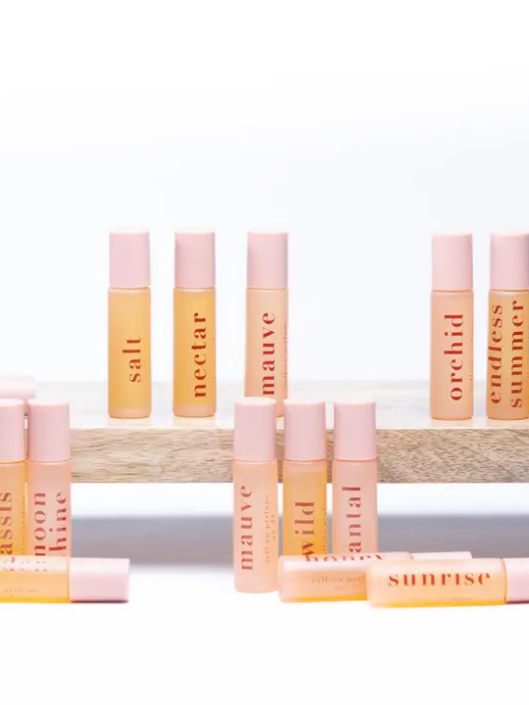 Ginger June Roll-On Body Perfume displayed among various scents, perfect for elevating your fragrance collection.