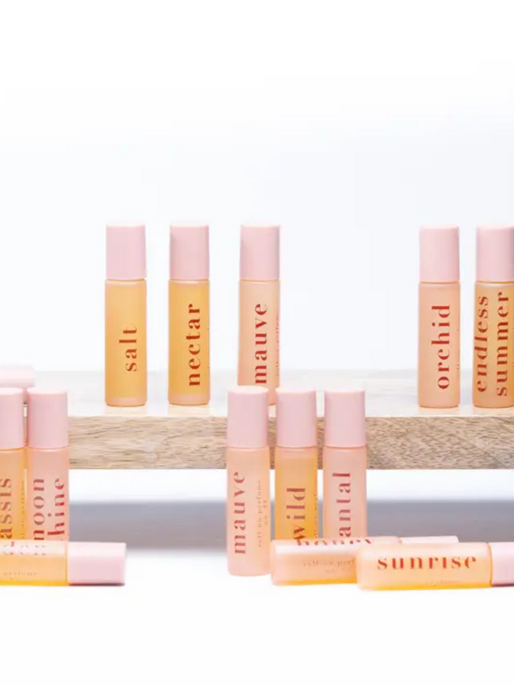 Ginger June Roll-On Body Perfume displayed among various scents, perfect for elevating your fragrance collection.