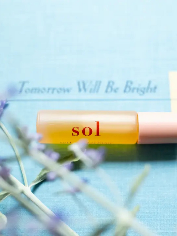 Ginger June Roll-On Body Perfume displayed with lavender, showcasing its natural, vegan ingredients for an elevated scent experience.