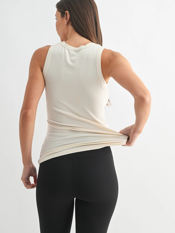Go-To Micro Rib Tank Top on a model; cream ribbed fabric, sleek, body-hugging fit ideal for layering.
