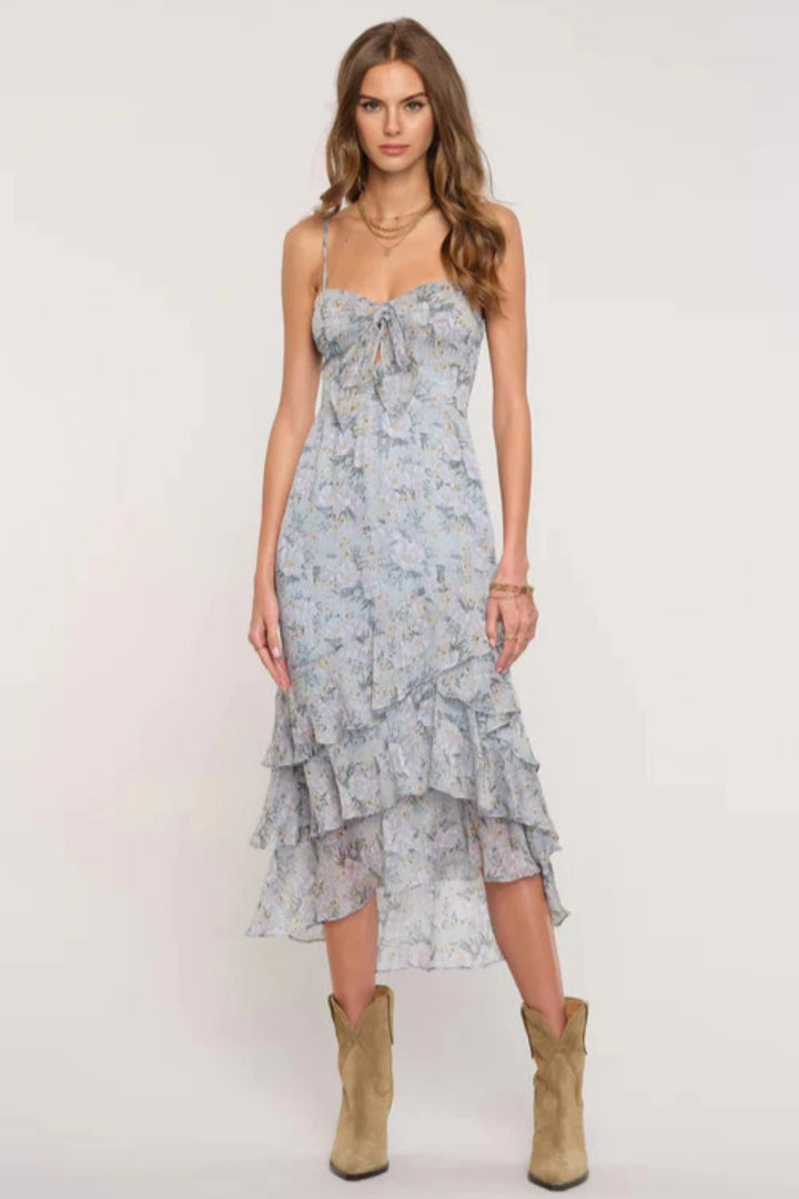 The Casta Dress features delicate ruffle details in romantic printed fabric. It has a tiered ruffled skirt and a cut-out detail along the bust. Pair with heels or dressy sandals for the perfect special occasion outfit.