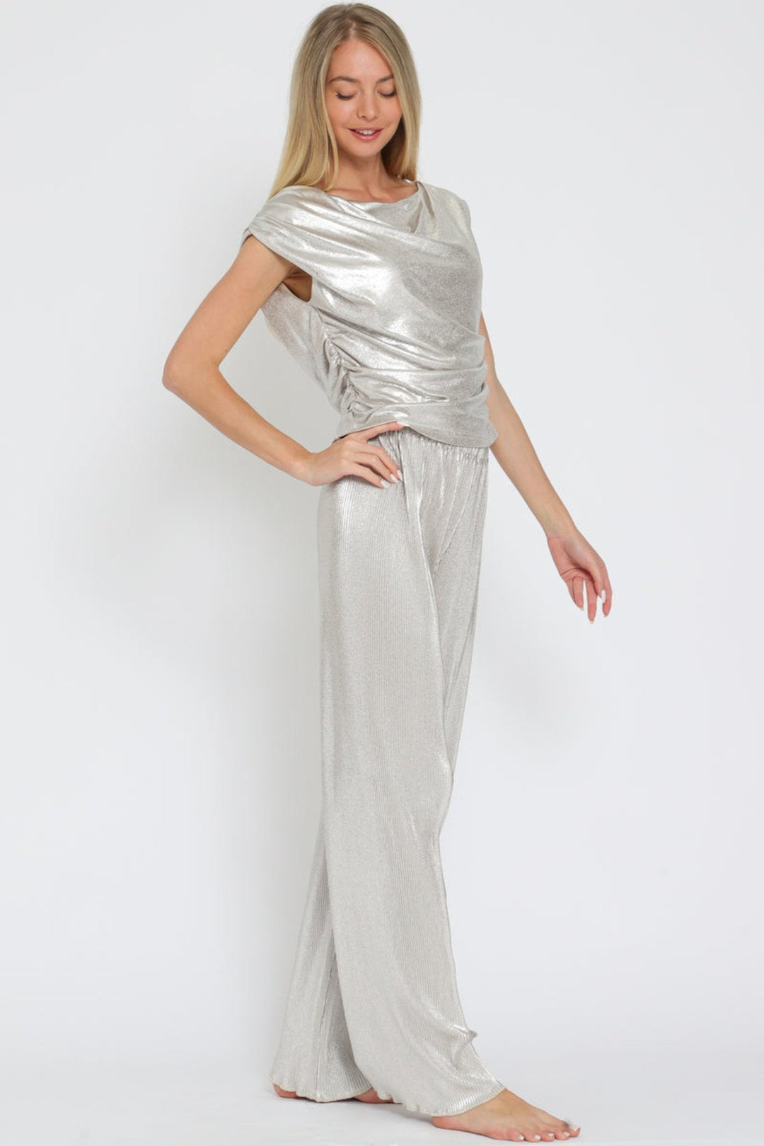 Eye-catching silver metallic set with a shiny texture and elegant cowl neck, perfect for any stylish occasion. 